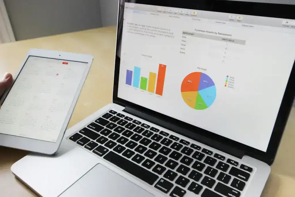 Company Formation FAQs – Infinite Corporate: laptop charts and a calendar tablet illustrating timelines, filings, CS01 reminders and compliance tracking.